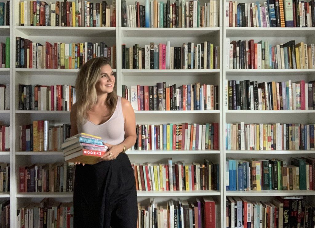 Brenna in office with books