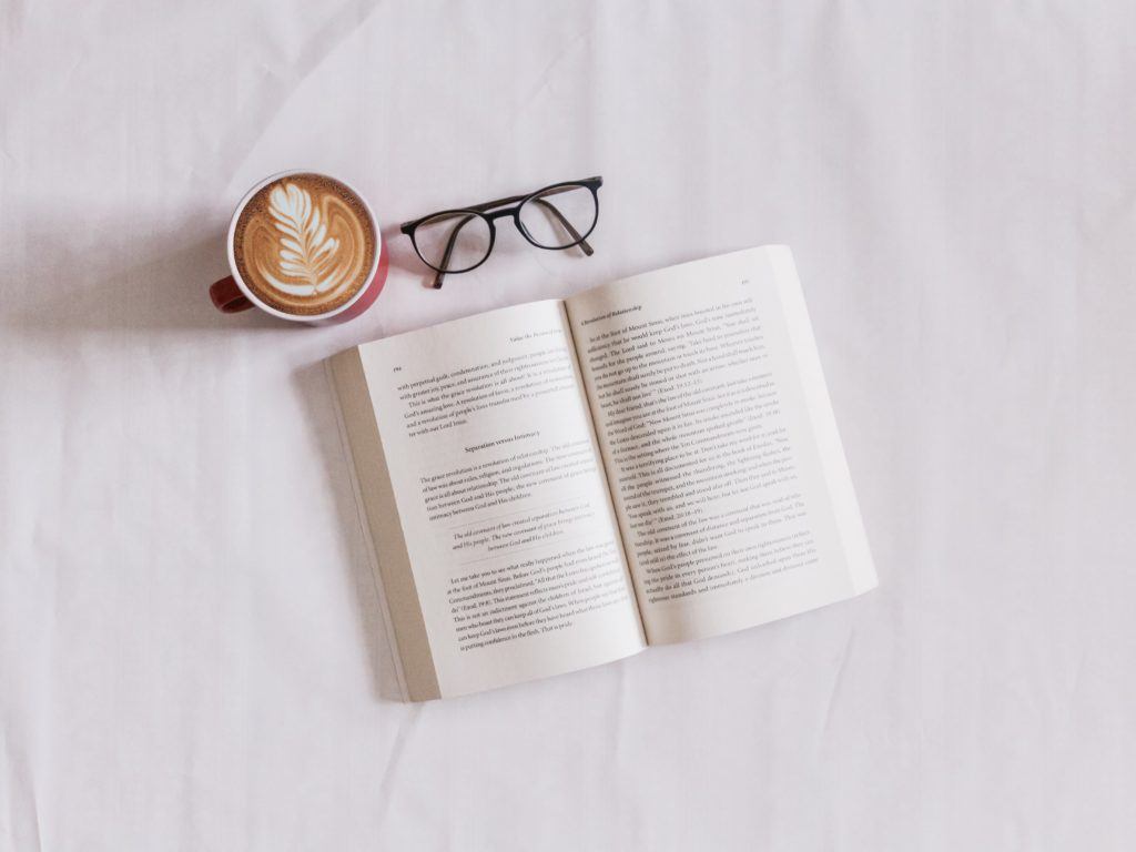 open book with glasses and coffee